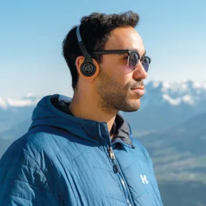 Person wearing JLab Rewind retro headphones with vinyl record player